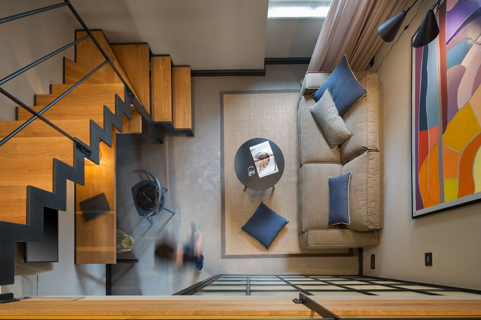 The living area and stairs viewed from the mezzanine level in Almayer hotel’s deluxe double room