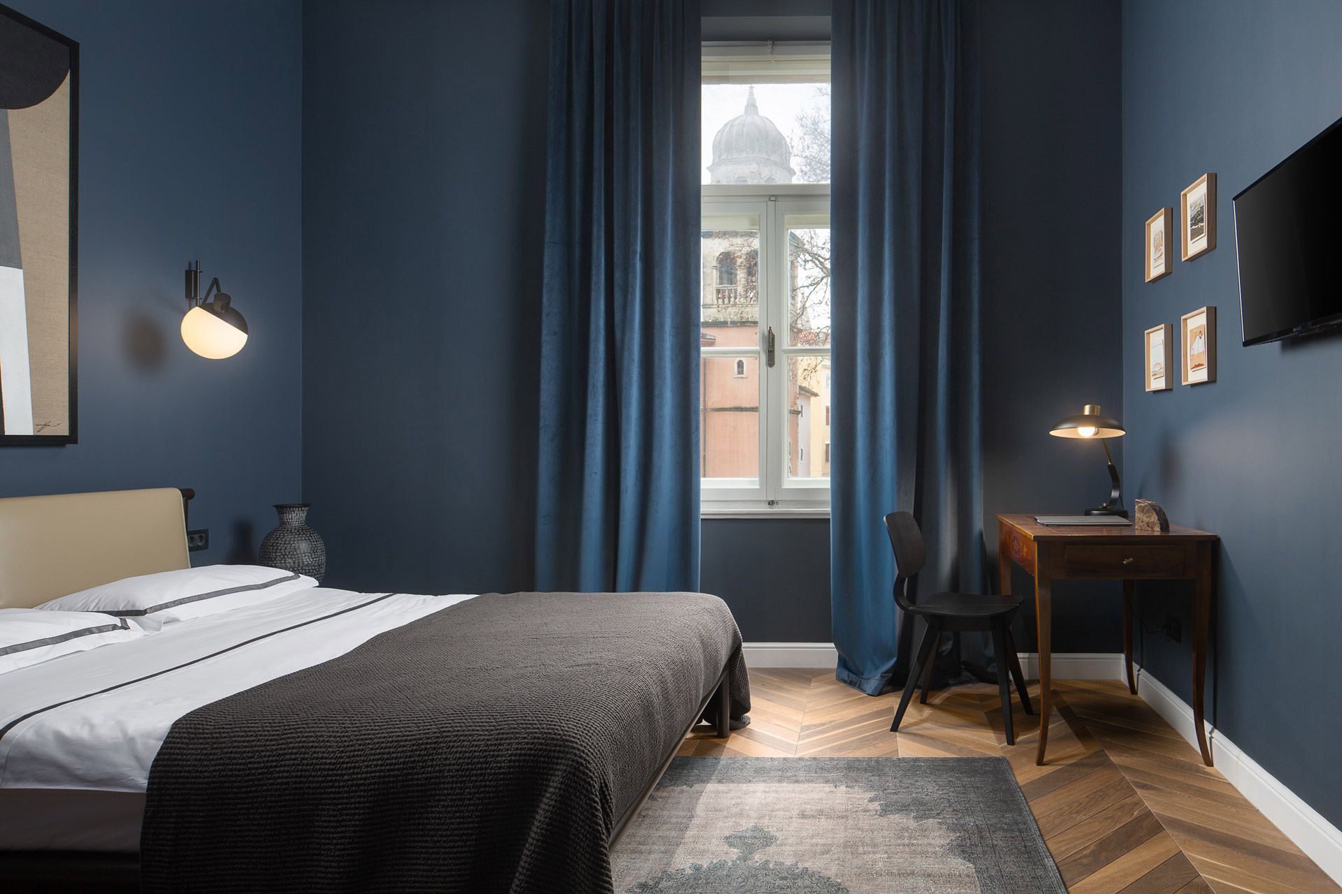 Cosy bedroom interior with a queen-size bed in Almayer hotel’s standard double room Brkan in dependance